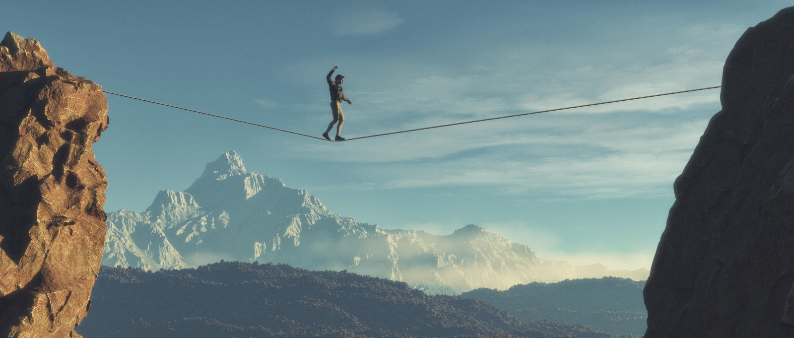 A tightrope walker crosses a gorge on a tightrope